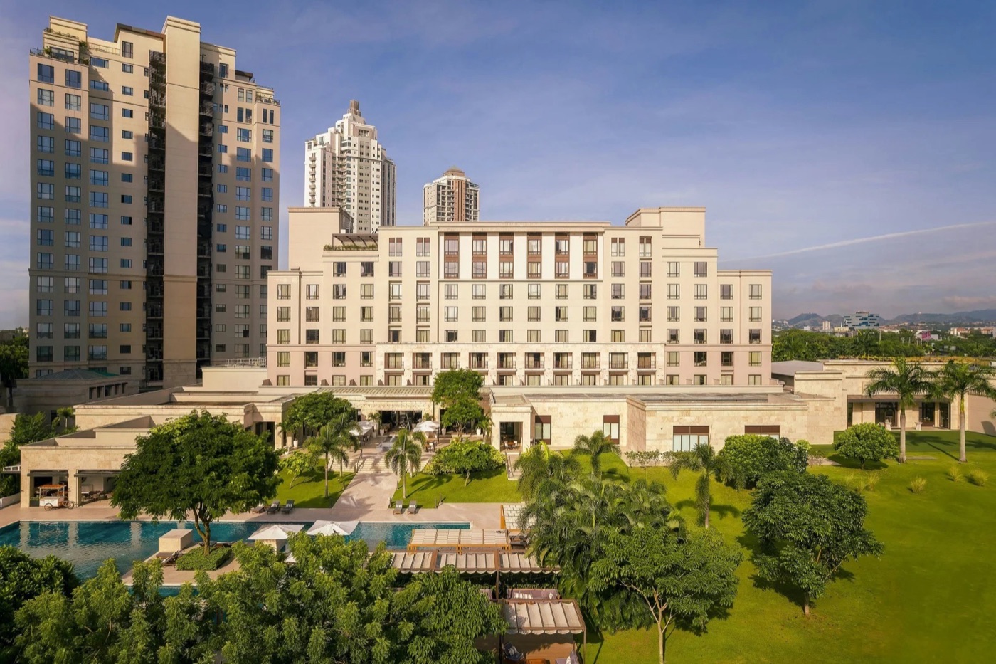 Aerial view of the Santa Maria hotel with its pool deck beside the golf course